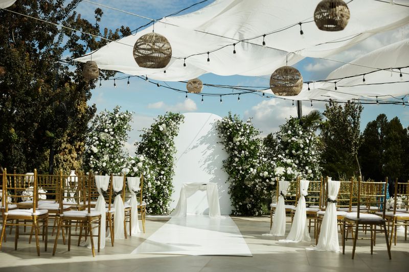 An elegant outdoor decoration setting for guests to celebrate the act of marriage.