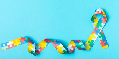 Colorful puzzle ribbon on blue background.
