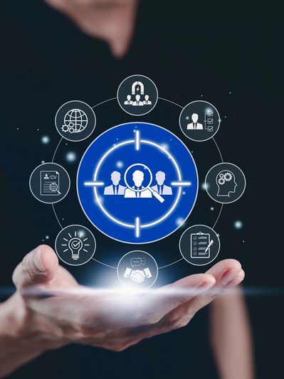 Hand holding virtual icons representing business teamwork and recruitment.