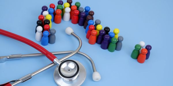 Stethoscope with colorful figurines arranged in a question mark shape.