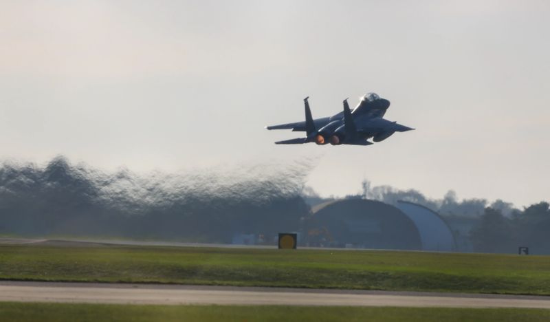 fighter jet taking off, landing at air base