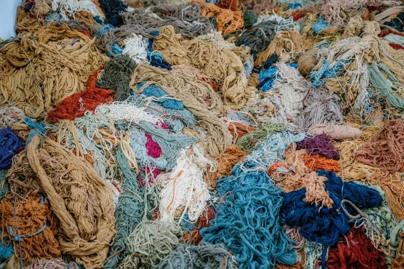 A pile of multicolored yarn threads symbolizing artistry, creativity, and traditional craftsmanship.