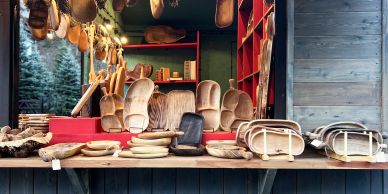 Various wooden clogs displayed in a shop.