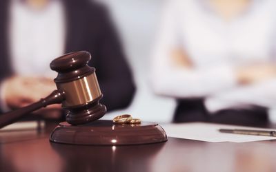 A small balance scale on a wooden podium in a courtroom.