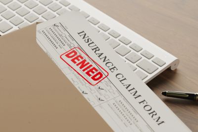 Insurance claim form marked denied.