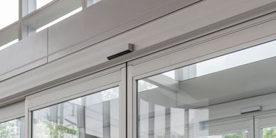 Entrance glass doors with automatic sensors in a modern building.
