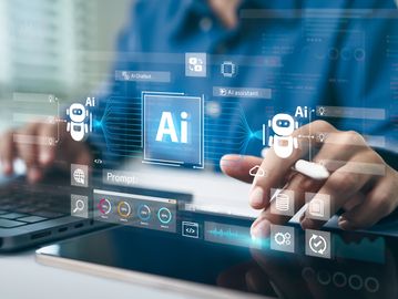 Person interacting with AI technology using a laptop and tablet, featuring AI assistant and chatbot icons.