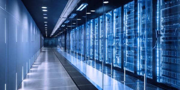 Futuristic data center hallway with illuminated server racks.