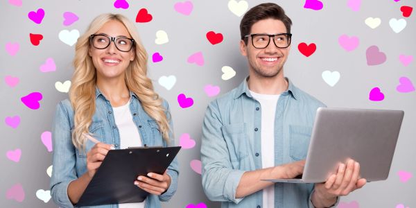 Two people smiling with hearts in the background.