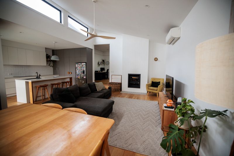 Spacious, well-lit modern living room with tasteful decor The open layout and stylish furnishings create a comfortable yet sophisticated environment for any contemporary home.