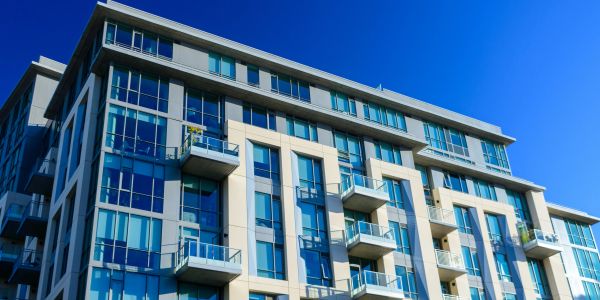 Modern apartment building under clear blue sky.