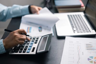 Professional bookkeeper, like R Robinson Bookkeeping, reviewing the financial reporting.