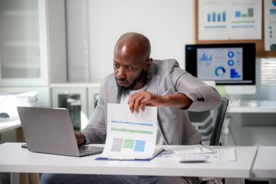 Man at desk working on bookkeeping.