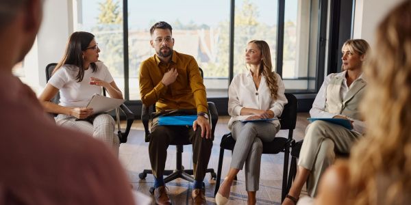 Group meeting with people discussing ideas in an office.