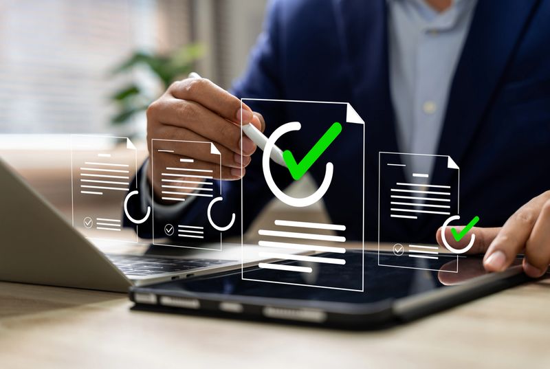 Business performance monitoring and evaluation concept, Take an assessment, Business man using laptop and tablet online checklist survey, Filling out digital checklist, Questionnaire with checkboxes.