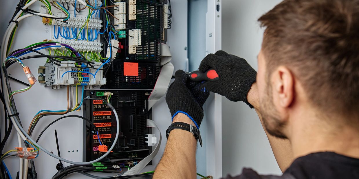 man working on electrical panel