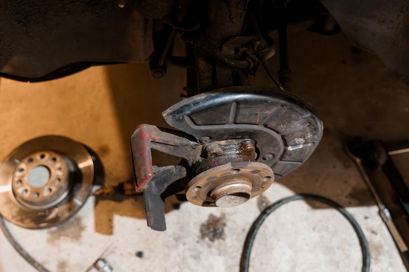 Detailed Close-Up of Automotive Brake System Components in a Workshop Setting.