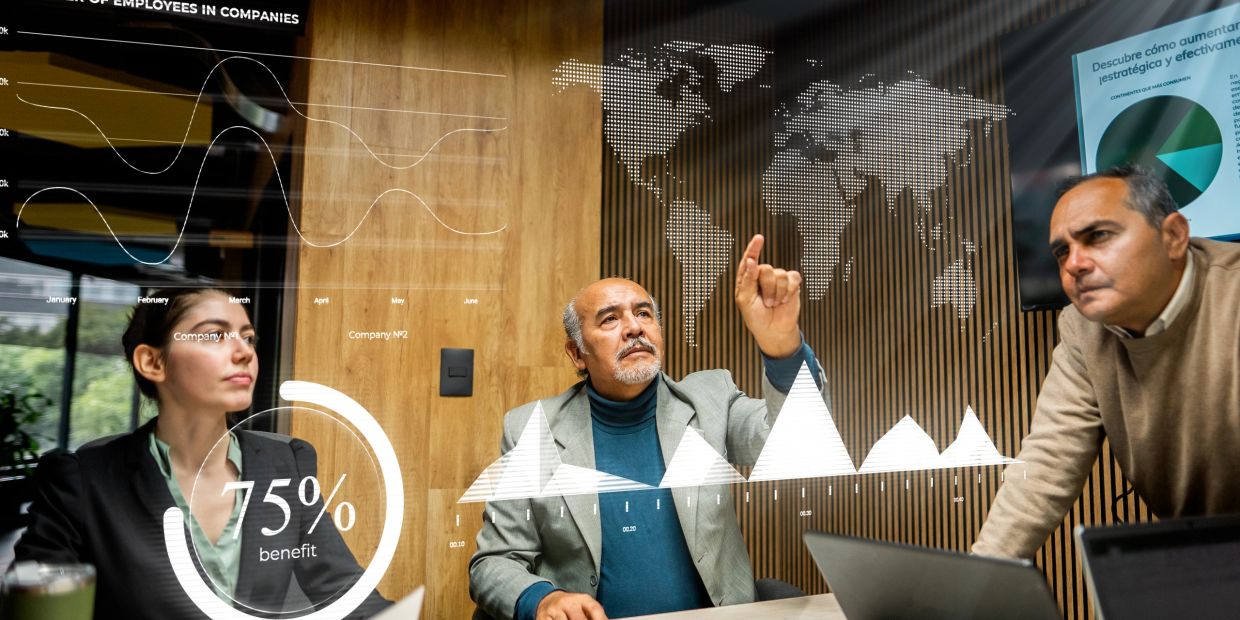 Reunión de negocios con gráficos y mapas digitales.