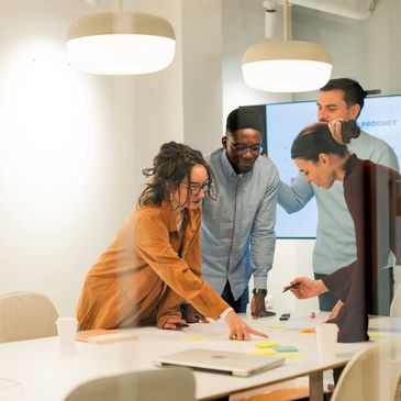Modern corridor with wooden chairs and large windows overlooking a parking lot and hills.