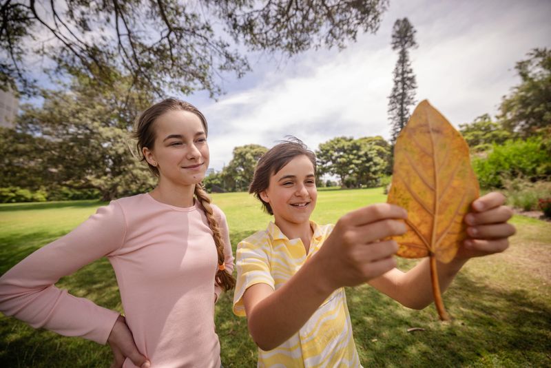 Smiling children playing in a sunny park during a joyful photoshoot