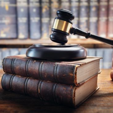 Judge's gavel on old law books.