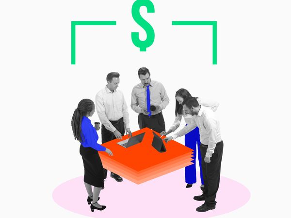 Business team collaborating on digital devices under a dollar sign symbol.