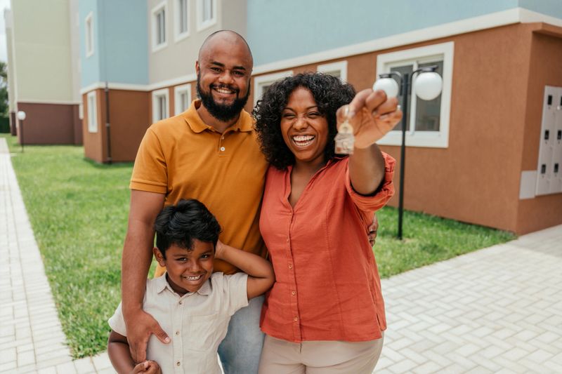 Portrait of family holding keys to their new home