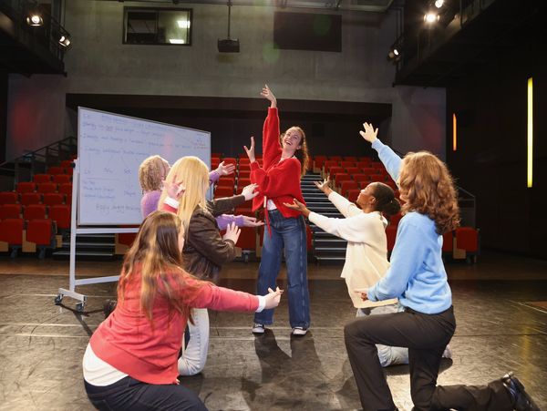 a woman practicing a dance, and other women making hand gestures