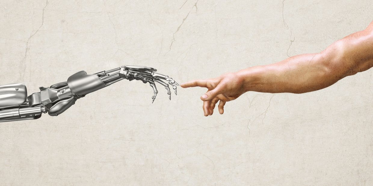 Human hand reaching out to touch a robotic hand on a textured background.