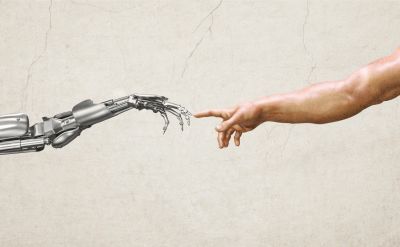 A robotic hand reaching out to a human hand.