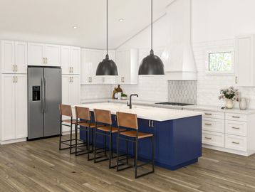 Renovated kitchen with white cabinetry, stainless steel appliances, quartz countertops and an island