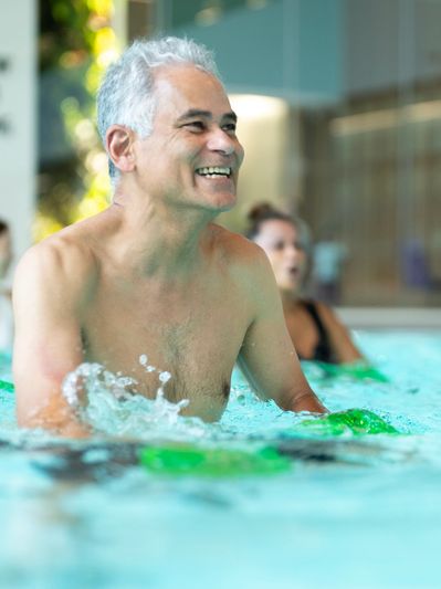 Seniors enjoying water exercise in an indoor pool.