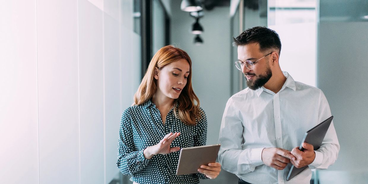 Modern office corridor with glass rooms.
