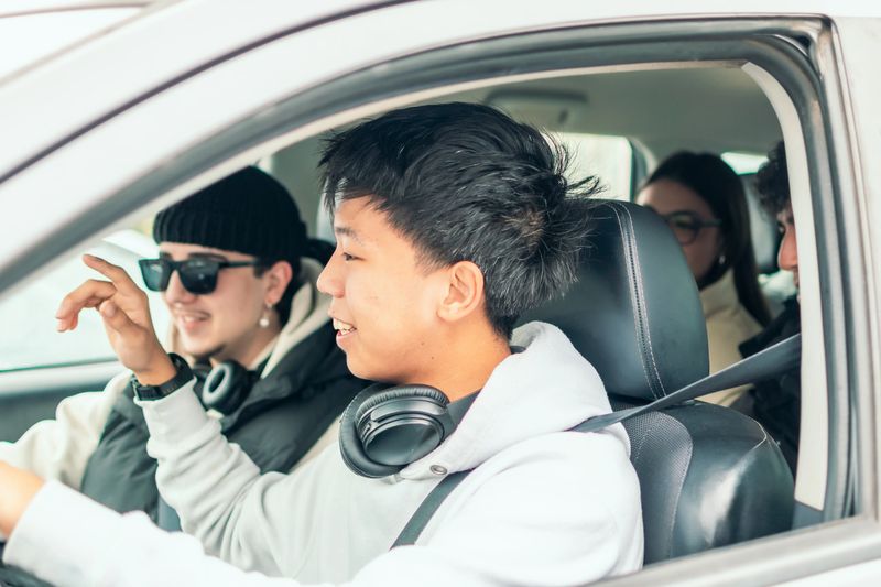 Four cheerful, diverse college students carpooling together, enjoying their ride to campus, sharing stories, laughing, and creating unforgettable memories along the way