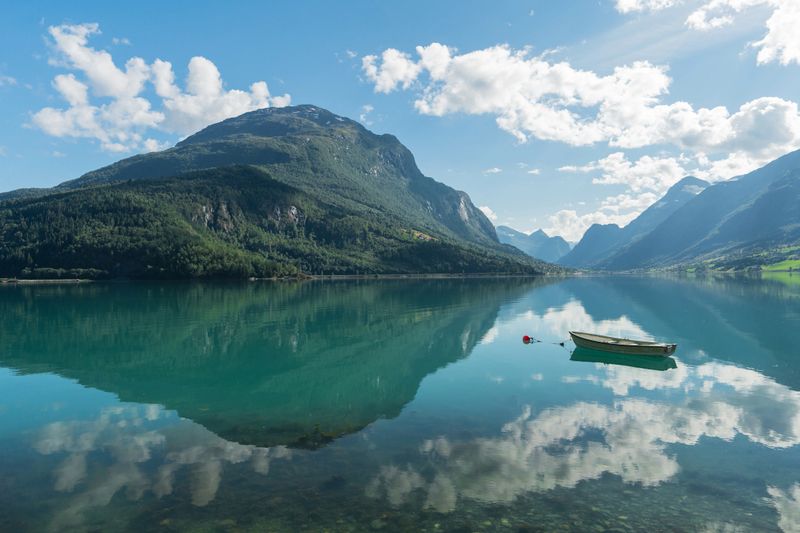 Boat on idyllic turquoise reflection  lake in Norway