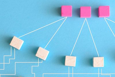 Wooden block flowchart on blue background.