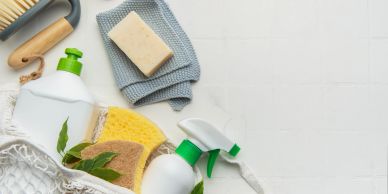 Eco-friendly cleaning supplies on a white surface.