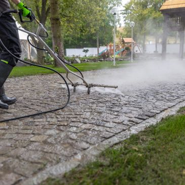 Technician soft washing a residential home with Hydro Pressure Pro