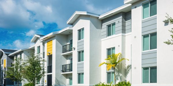 Modern apartment complex with balconies on a clear day.