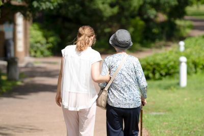 Two women walking together outside.
