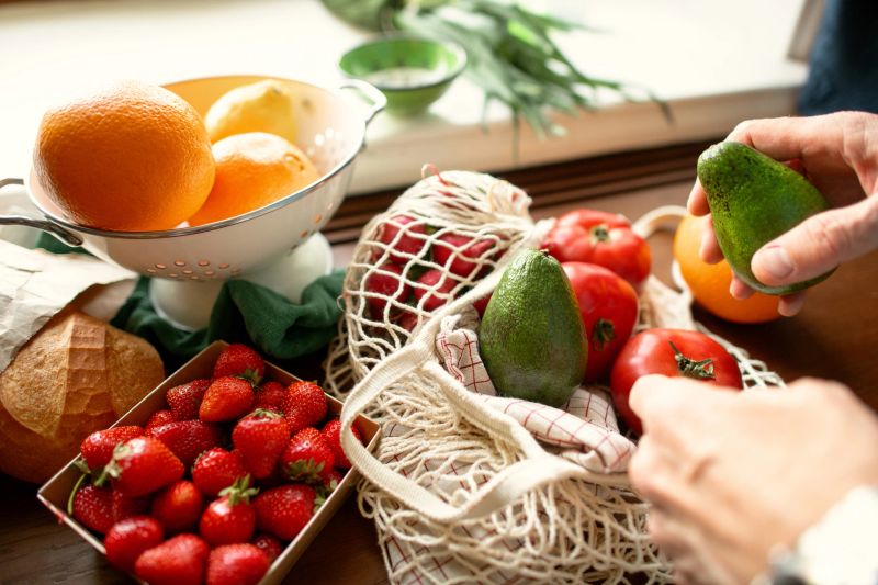 Senior man unpacking groceries at kitchen