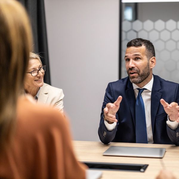 Business professionals engaged in a discussion during a meeting.