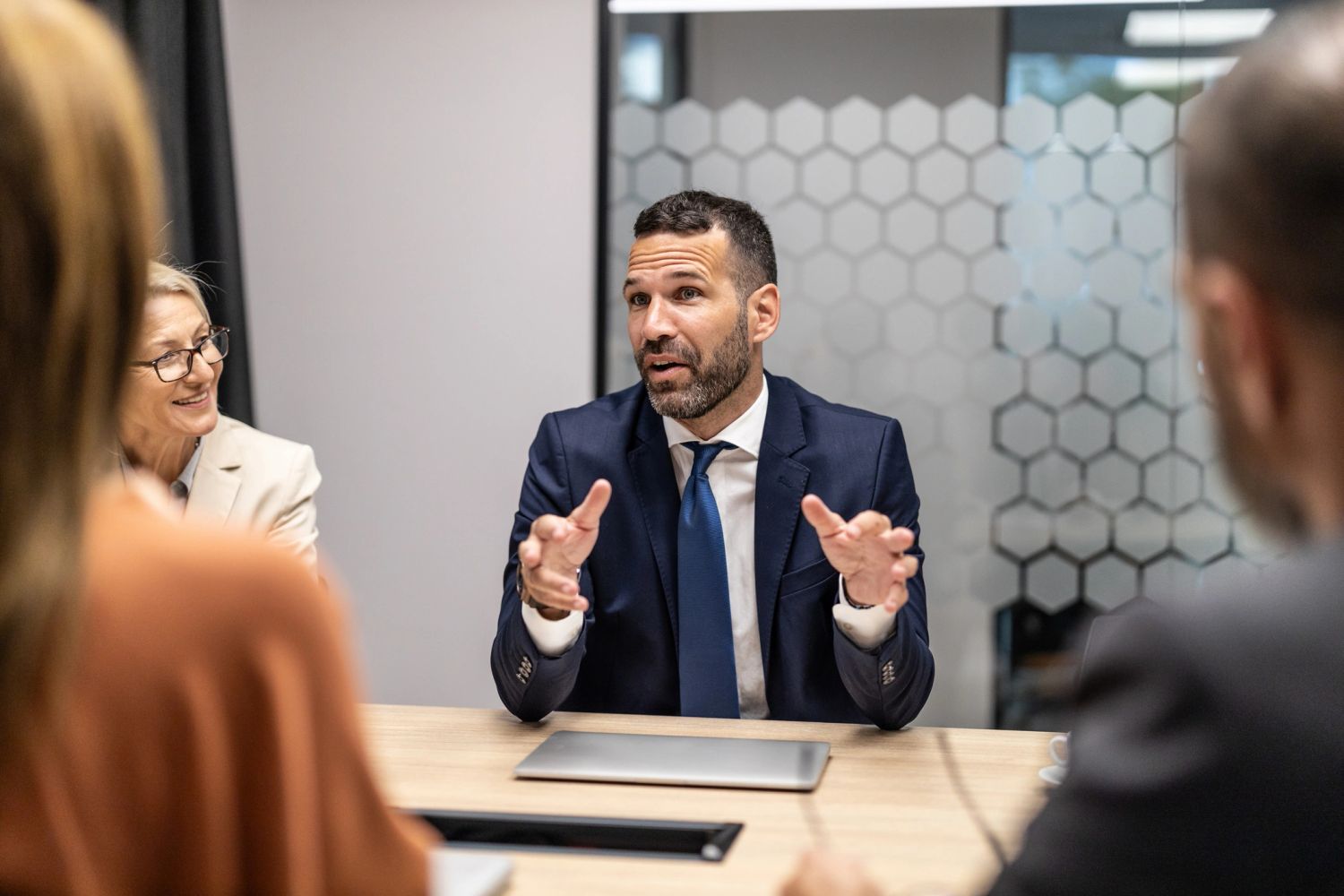 Businessman explaining a point during a meeting with colleagues.