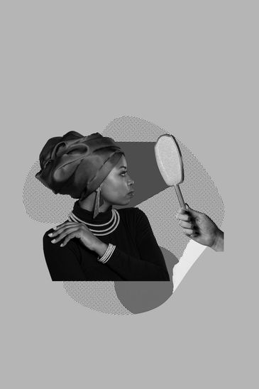 Woman looking at a handheld mirror with a contemplative expression.