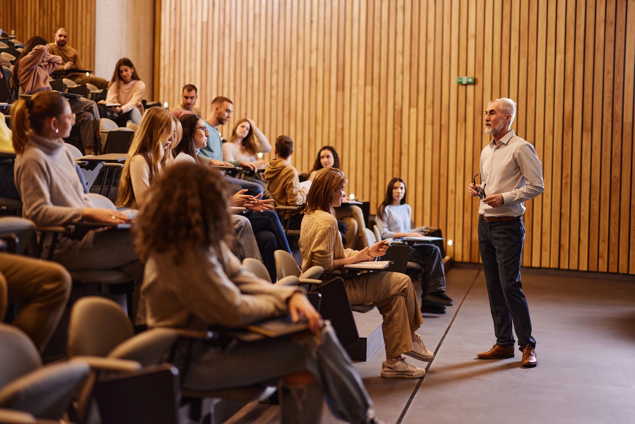 Professor giving a lecture in a modern classroom.
