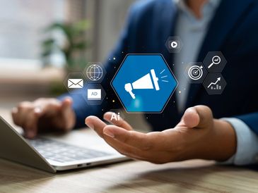 Businessman using AI-powered digital marketing icons on laptop.