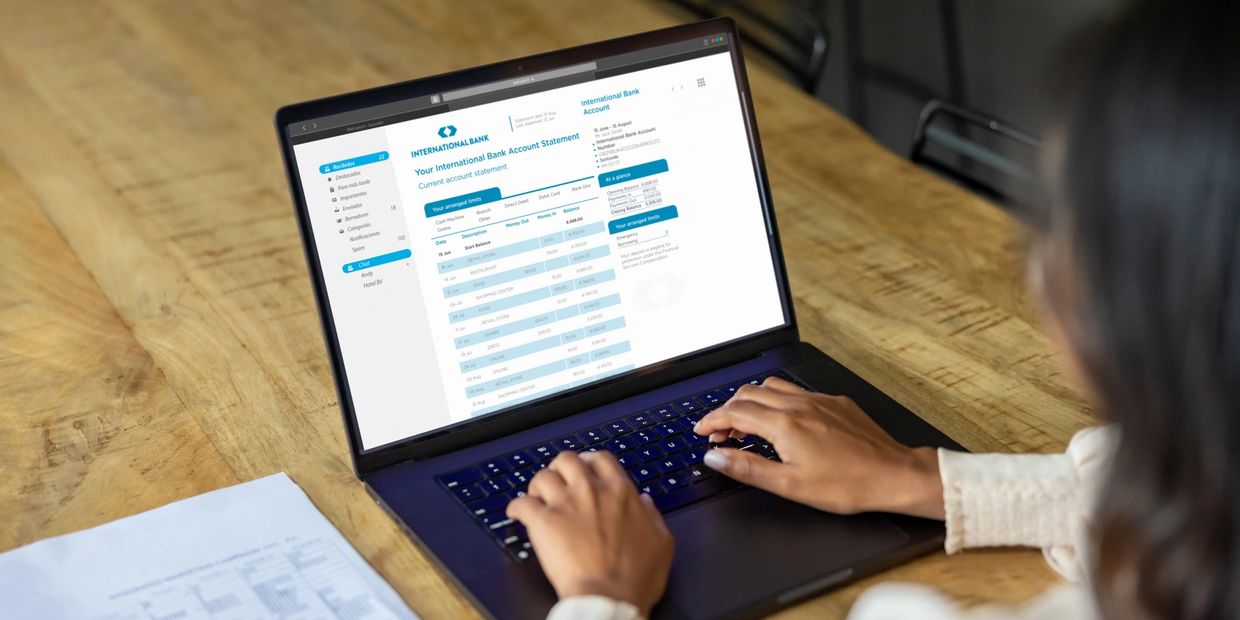 Bookkeeper working on laptop with graphics for money and tax