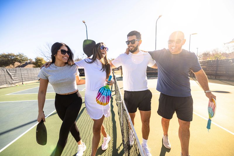 Group of hispanic friends playing pickleball
