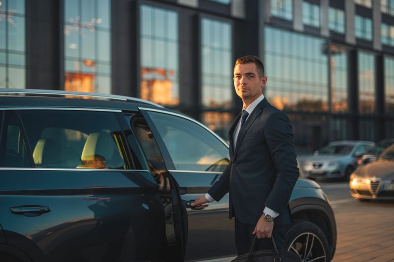 Shot of mid adult businessman entering his vehicle.