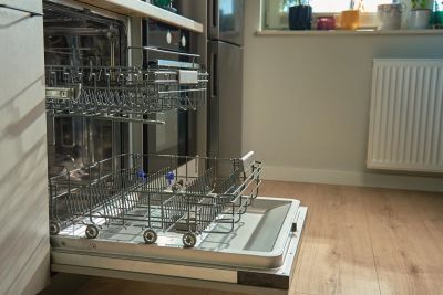 Open dishwasher in modern kitchen.